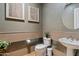 Powder room featuring decorative wall paper, tile wainscotting and modern fixtures at 1500 E Sagittarius Pl, Chandler, AZ 85249