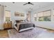 Bright bedroom with neutral decor, wood floors, ceiling fan and abundant natural light at 1500 E Sagittarius Pl, Chandler, AZ 85249
