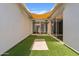 Bright courtyard featuring artificial turf, shade covering, white stucco walls and outdoor access at 1500 E Sagittarius Pl, Chandler, AZ 85249