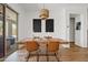 Stylish dining room with a rustic table, tan leather chairs, and a modern chandelier above at 1500 E Sagittarius Pl, Chandler, AZ 85249