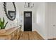 Bright foyer features wood floors, a decorative mirror, and a stylish console table at 1500 E Sagittarius Pl, Chandler, AZ 85249