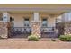 Cozy front porch with stone pillars, seating, and a brick pathway at 1500 E Sagittarius Pl, Chandler, AZ 85249