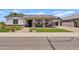 Inviting single-story home with beautiful landscaping and a cozy front porch at 1500 E Sagittarius Pl, Chandler, AZ 85249