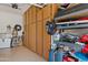 Garage interior featuring wooden storage cabinets with various stored items on shelving at 1500 E Sagittarius Pl, Chandler, AZ 85249