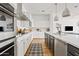 Spacious modern kitchen featuring white cabinets, stainless steel appliances, and an island with a breakfast bar at 1500 E Sagittarius Pl, Chandler, AZ 85249