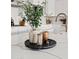 Stylish kitchen island decor with greenery, candle holders, and a decorative tray on a white countertop at 1500 E Sagittarius Pl, Chandler, AZ 85249