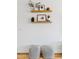 Stylishly decorated living room wall shelves with decorative items, plants, and framed pictures at 1500 E Sagittarius Pl, Chandler, AZ 85249