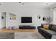 Living room featuring a comfy gray sectional sofa, stylish decor, and natural lighting at 1500 E Sagittarius Pl, Chandler, AZ 85249
