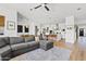 Open-concept living area with a large sofa, hardwood floors, and a dining area in the background at 1500 E Sagittarius Pl, Chandler, AZ 85249