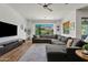 Bright living room with a gray sectional sofa, stylish decor, and views of the backyard at 1500 E Sagittarius Pl, Chandler, AZ 85249