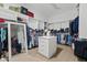 Spacious walk-in closet featuring built-in shelving and hanging rods for ample storage at 1500 E Sagittarius Pl, Chandler, AZ 85249