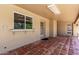 Back porch featuring tile floors, neutral walls, and an entrance to the backyard at 1735 E Hope St, Mesa, AZ 85203