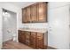 Bar area featuring dark wood cabinets, granite countertop, and hardwood floors at 1735 E Hope St, Mesa, AZ 85203