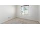 Neutral bedroom featuring a large window with a view and neutral carpet at 1735 E Hope St, Mesa, AZ 85203
