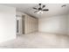 Vaulted bedroom features built in storage, neutral carpet, and a ceiling fan at 1735 E Hope St, Mesa, AZ 85203