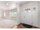 Bright entryway with wood floors, white walls, and a sidelight-adorned front door at 1735 E Hope St, Mesa, AZ 85203