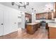 Open kitchen featuring wood cabinets, stainless steel appliances, and a center island with stone countertops at 1735 E Hope St, Mesa, AZ 85203
