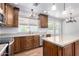 Stylish kitchen featuring custom wood cabinetry, granite countertops, and stainless steel appliances at 1735 E Hope St, Mesa, AZ 85203