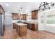 Spacious kitchen with wood cabinetry, granite countertops, and stainless steel appliances at 1735 E Hope St, Mesa, AZ 85203