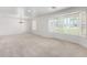 Spacious living room with plush carpet, a bay window, and neutral decor at 1735 E Hope St, Mesa, AZ 85203