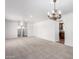 Expansive living room with neutral carpet, white walls, and views into the kitchen at 1735 E Hope St, Mesa, AZ 85203