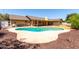 View of backyard featuring a kidney shaped pool, covered patio, and partial fence view at 1735 E Hope St, Mesa, AZ 85203
