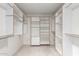 Walk-in closet with custom shelving and drawers provides ample storage space at 1735 E Hope St, Mesa, AZ 85203