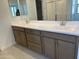 This bathroom has a double sink vanity with modern fixtures and a neutral color scheme at 18001 W Lupine Ave, Goodyear, AZ 85338