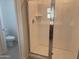 This bathroom features a glass-enclosed shower, a toilet and a neutral palette for a sleek, modern look at 18001 W Lupine Ave, Goodyear, AZ 85338