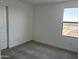 This bedroom is simple, with neutral carpet and walls and a window to let in light at 18001 W Lupine Ave, Goodyear, AZ 85338