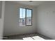 This is a bright bedroom with a window view and neutral carpet, offering a cozy and inviting space at 18001 W Lupine Ave, Goodyear, AZ 85338