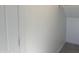 Clean, neutral closet with white walls and trim, and light-colored tile flooring at 18001 W Lupine Ave, Goodyear, AZ 85338