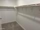 A simple walk-in closet features a rod with shelving for optimal storage at 18001 W Lupine Ave, Goodyear, AZ 85338