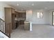 Modern kitchen with a large center island, stainless appliances and neutral backsplash at 18001 W Lupine Ave, Goodyear, AZ 85338