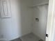 This is a basic laundry room featuring hookups for appliances, shelving, and neutral colors at 18001 W Lupine Ave, Goodyear, AZ 85338