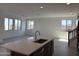 Spacious living room with large windows, recessed lighting, and tile flooring at 18001 W Lupine Ave, Goodyear, AZ 85338