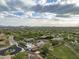 Community with an aerial view of the pool, buildings, and desert landscape at 18127 N 98Th Way, Scottsdale, AZ 85255