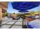 Beautiful backyard with a custom fire pit, BBQ area, outdoor seating, lush plants and stunning mountain views at 18127 N 98Th Way, Scottsdale, AZ 85255