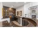 A modern bar features open shelving, black cabinets, and a custom countertop at 18127 N 98Th Way, Scottsdale, AZ 85255