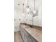 Bathroom with a double vanity, granite countertops, and pendant lighting fixtures at 18127 N 98Th Way, Scottsdale, AZ 85255