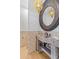 Elegant bathroom with a stone sink and an ornate circular mirror with a designer pendant light at 18127 N 98Th Way, Scottsdale, AZ 85255