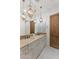 Bathroom with a double vanity, granite countertops, and pendant lighting fixtures at 18127 N 98Th Way, Scottsdale, AZ 85255