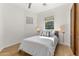 Bedroom with a queen bed, wood floors, neutral colors, and lots of natural light at 18127 N 98Th Way, Scottsdale, AZ 85255