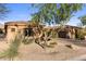Landscaped front yard with mature trees and stone accents enhances this inviting home at 18127 N 98Th Way, Scottsdale, AZ 85255