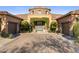 Inviting front entrance with arched greenery and matching topiaries flanking the glass front door at 18127 N 98Th Way, Scottsdale, AZ 85255