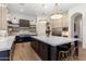 A modern kitchen boasts a spacious island, stainless steel appliances, and stylish pendant lighting at 18127 N 98Th Way, Scottsdale, AZ 85255