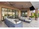 Covered patio with comfortable seating and views into the home at 18127 N 98Th Way, Scottsdale, AZ 85255