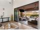 Open sliding glass doors invite outdoor living to a covered patio, pool, and mountain views at 18127 N 98Th Way, Scottsdale, AZ 85255