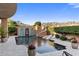 Resort-style pool features a slide, seating, and lush landscaping at 18127 N 98Th Way, Scottsdale, AZ 85255