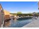 Resort-style pool includes a rock waterfall feature and mountain views at 18127 N 98Th Way, Scottsdale, AZ 85255